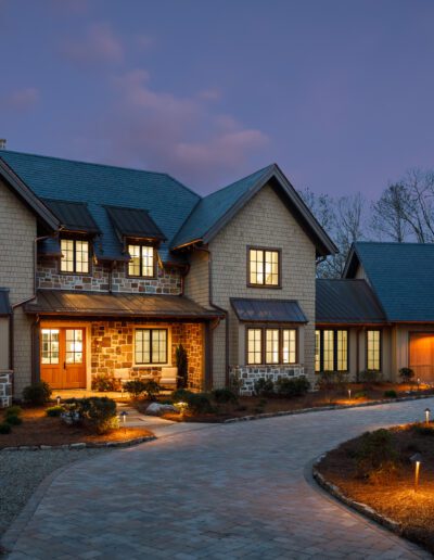 A home with a stone driveway and walkway at dusk.