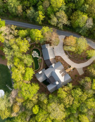 An aerial view of a house surrounded by trees.
